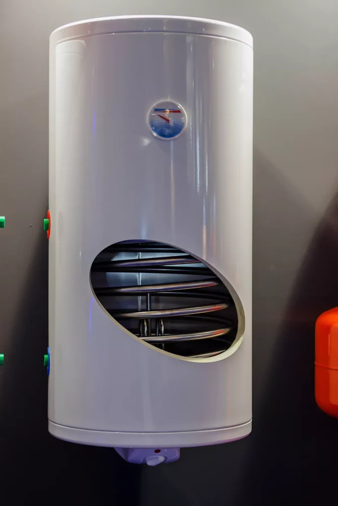 A cutaway diagram of a high-efficiency domestic hot water heater showing internal heating coils, insulation, and pressure gauges.